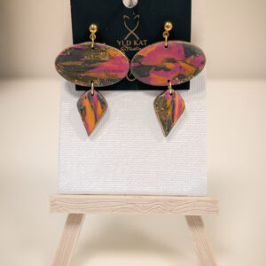 Handmade polymer clay earrings with marbled magenta, gold, orange, and charcoal ovals paired with matching geometric drops,