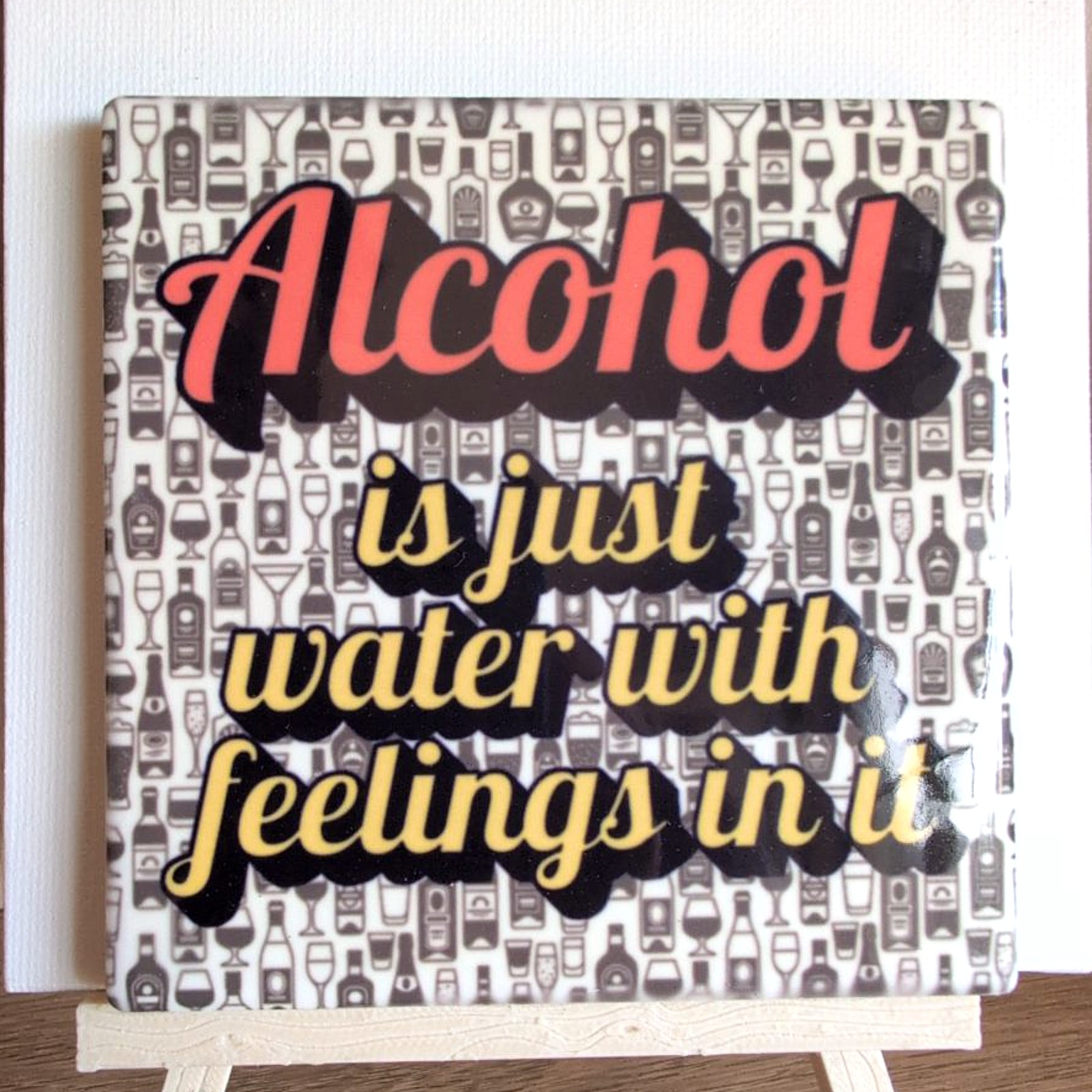 Alcohol Is Just Water With Feelings ceramic coaster by Ayantika Sen, YldKat Studios