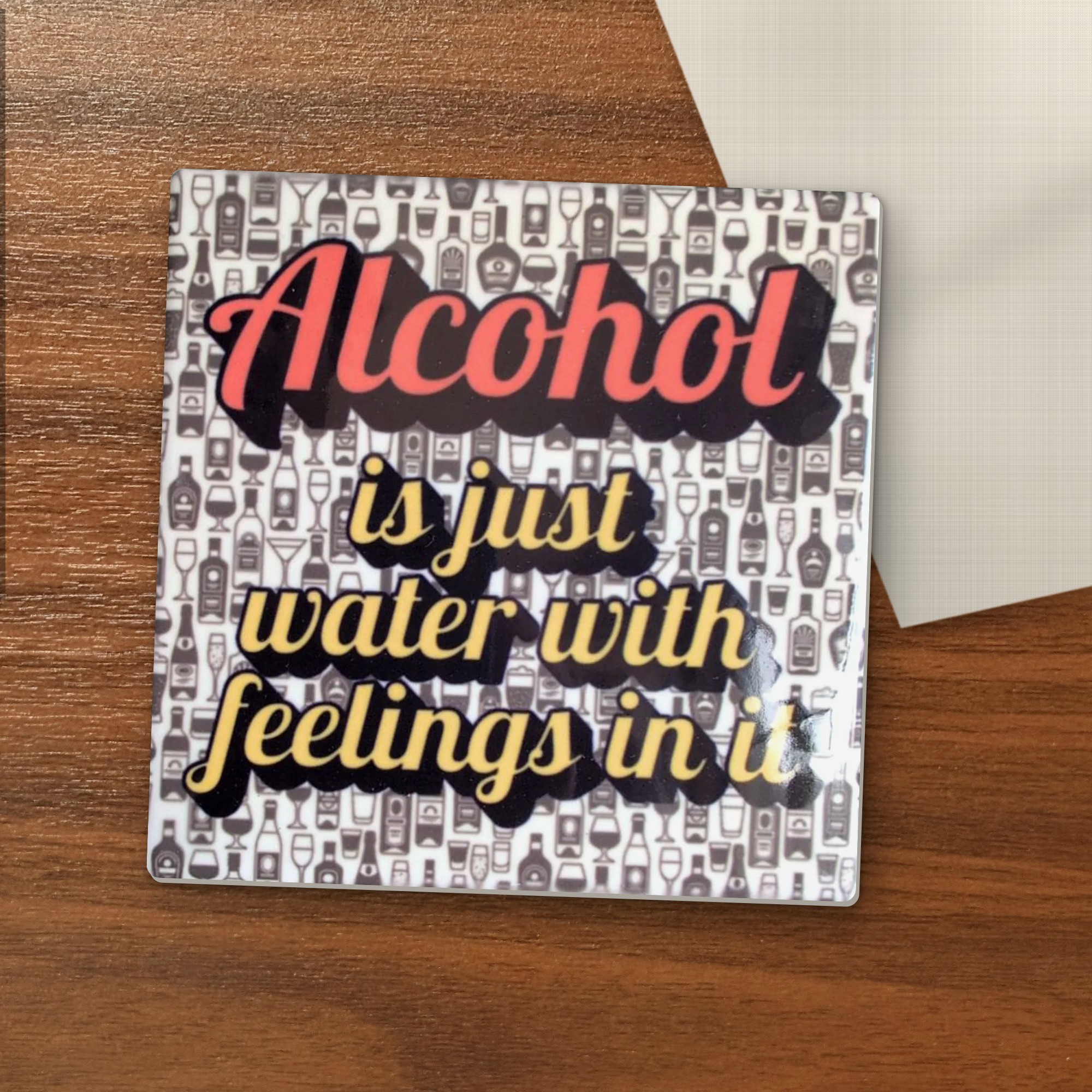 Alcohol Is Just Water With Feelings coaster on a wooden table