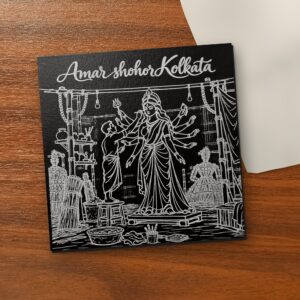 Amar Shohor Kolkata - Durga Pooja 5x5 inch black engraved art canvas on a wooden table