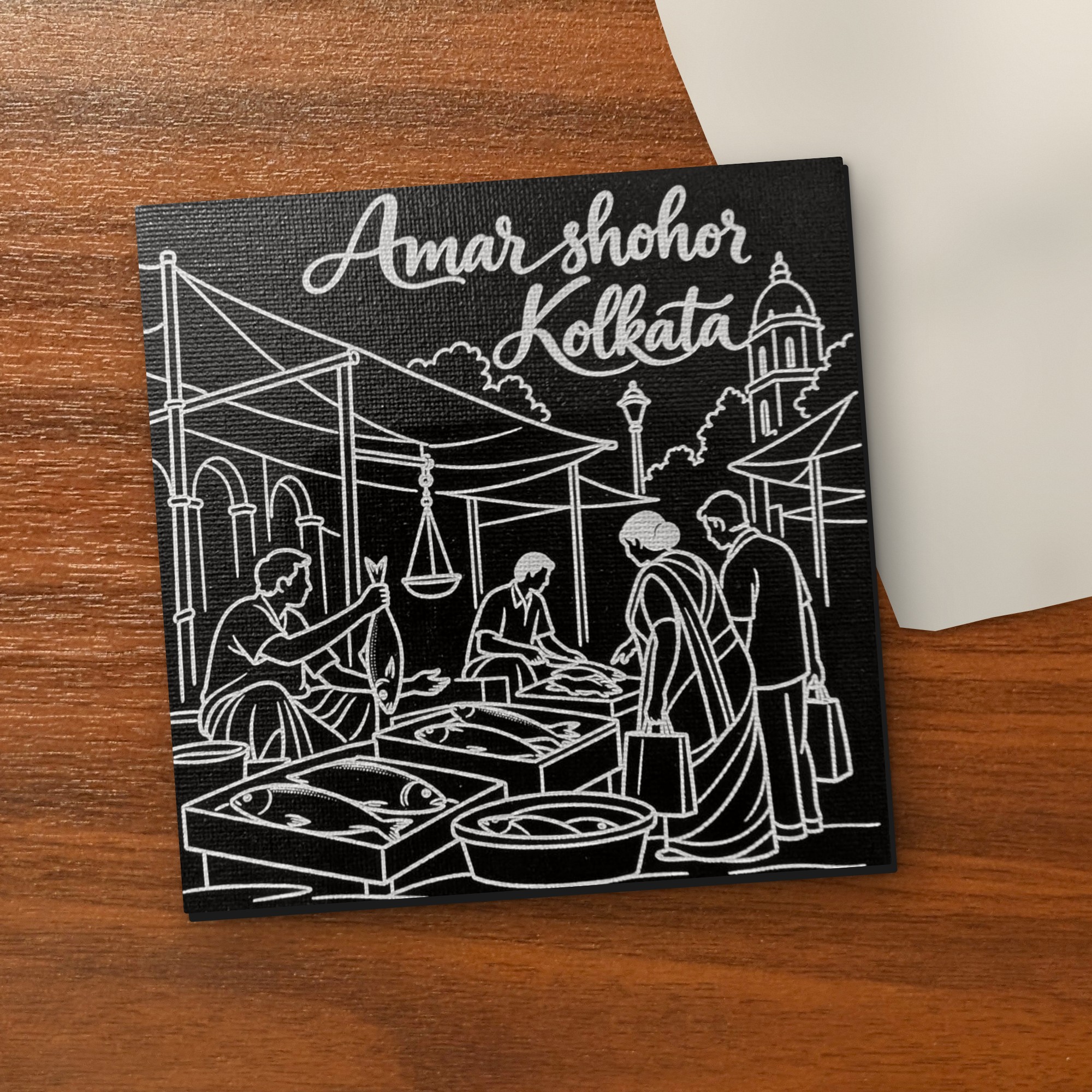 Amar Shohor Kolkata - Fish Market 5x5 inch black engraved art canvas on a wooden table