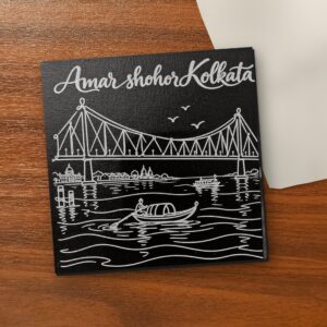 Amar Shohor Kolkata - Howrah Bridge 5x5 inch black engraved art canvas on a wooden table