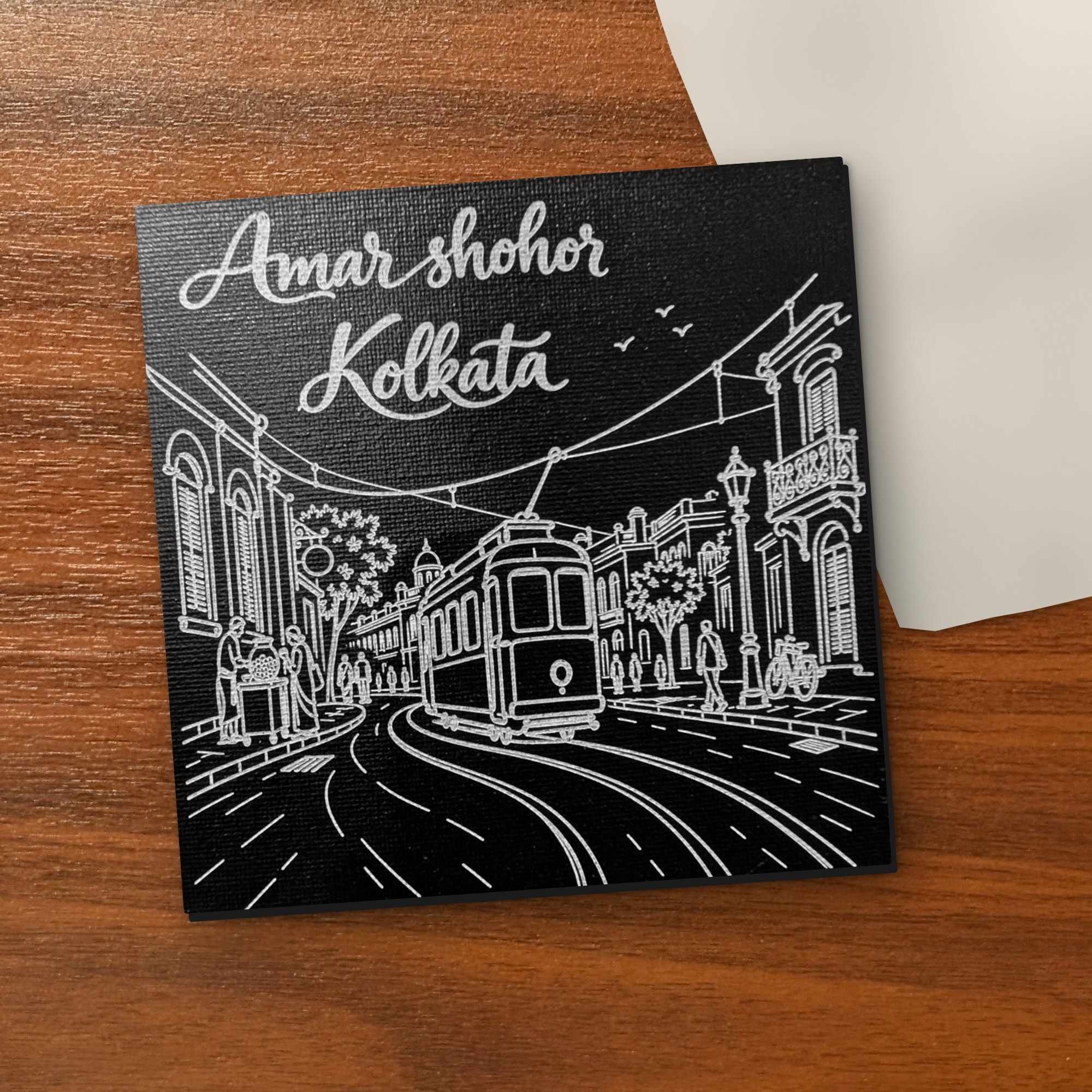 Amar Shohor Kolkata - Tram Edition 5x5 inch black engraved art canvas on a wooden table