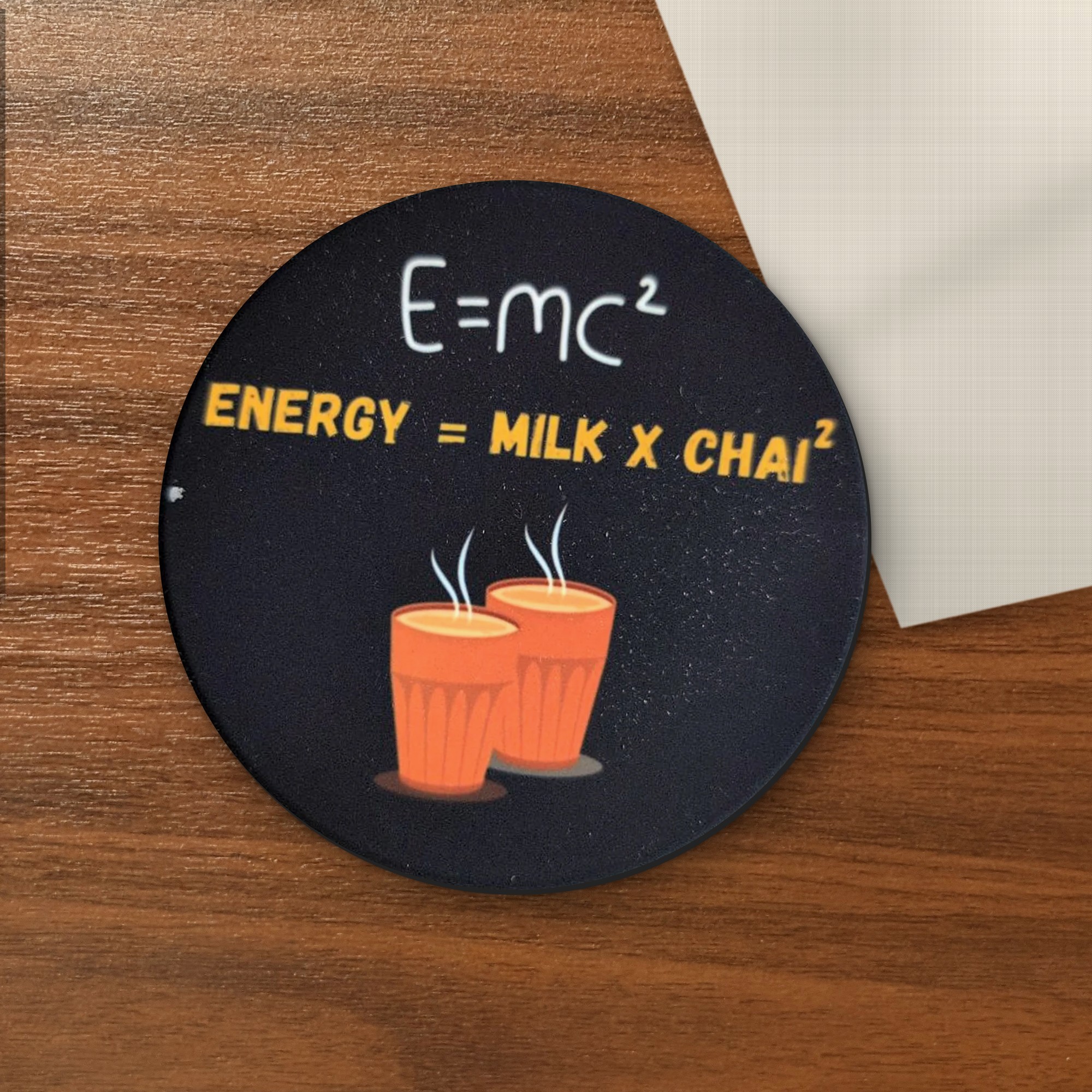 E=MC² (Energy = Milk × Chai²) coaster on a wooden table