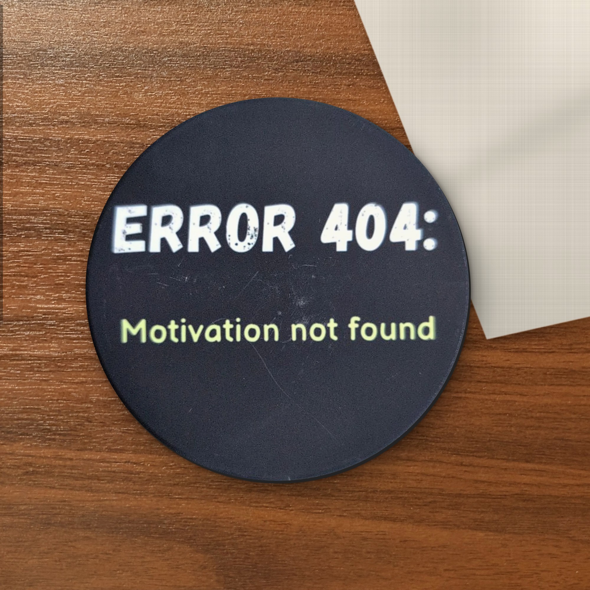 Error 404: Motivation Not Found coaster on a wooden table