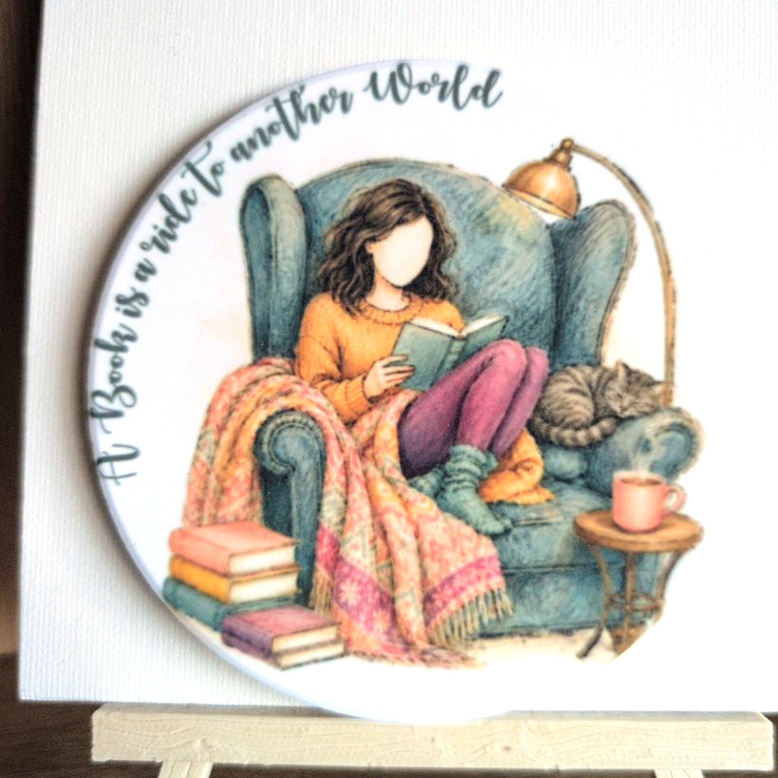 A Book Is a Ride to Another World ceramic coaster by Ayantika Sen, YldKat Studios