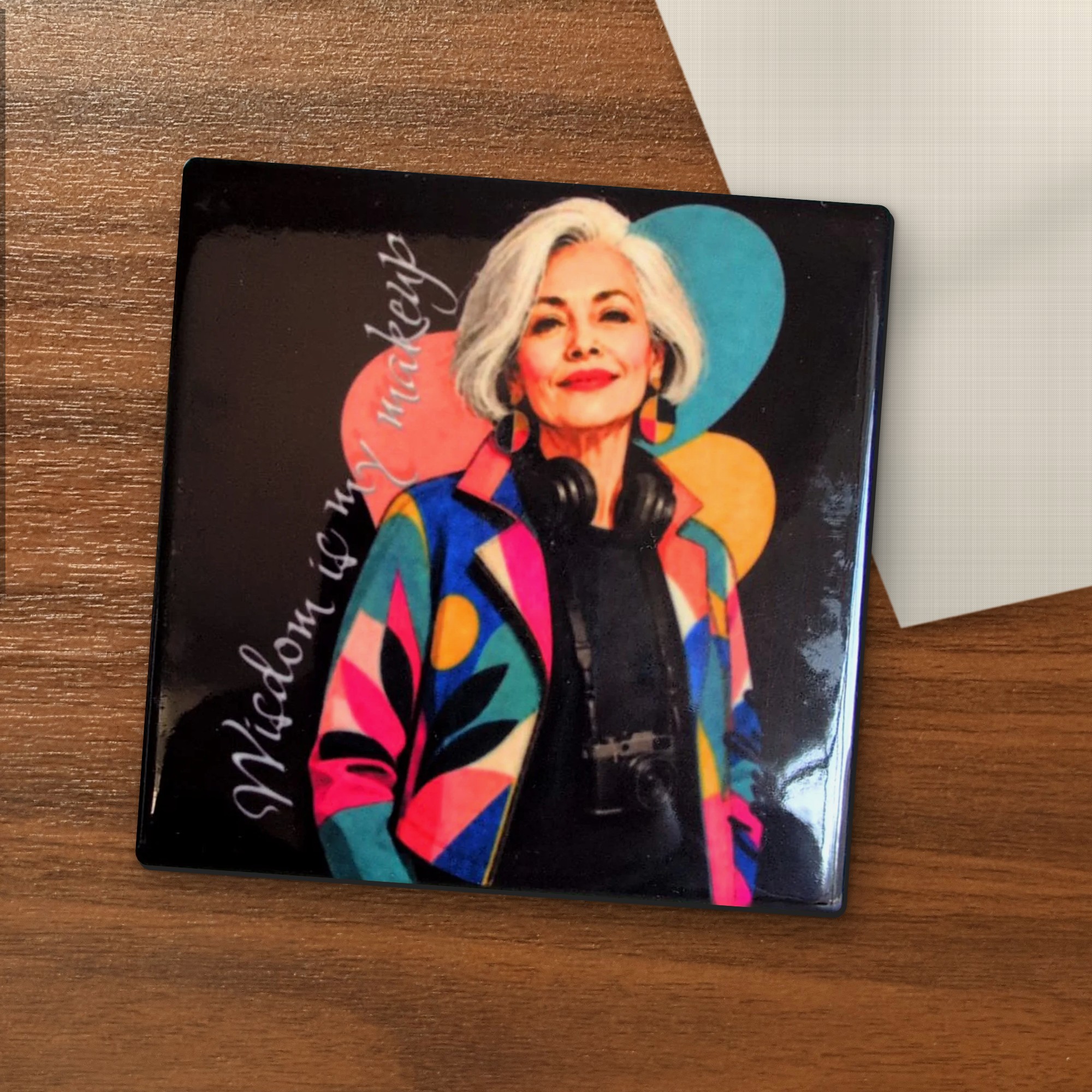 Wisdom Is My Makeup coaster on a wooden table